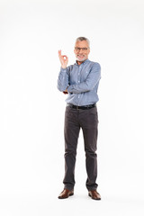 Old man looking camera and showing ok gesture isolated