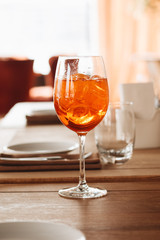 Delicious cocktail with ice cubes on wooden table