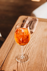 Delicious cocktail with ice cubes on wooden table