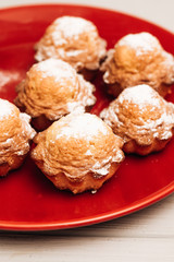 Delicious sweet cupcakes on red plate, delicious homemade dessert