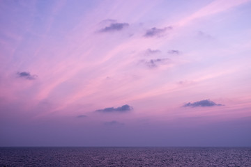 Fototapeta na wymiar Twilight sunset sky with beautiful clouds over sea