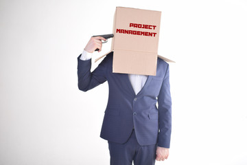 The businessman is holding a box with the inscription:PROJECT MANAGEMENT