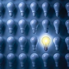 One glowing light bulb standing out from the unlit bulbs on dark blue background , individuality and different creative business bright idea concepts . 3D rendering.