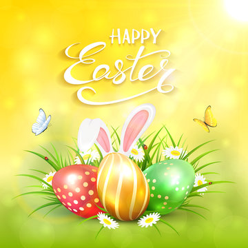 Yellow sunny background with Easter eggs and rabbit ears in grass