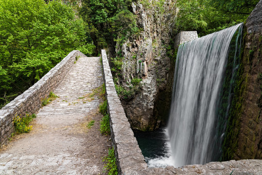 Traditional stone bridge and waterfall near Paleokaria village in Thessaly, Greece