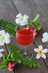 Obraz na płótnie Canvas The red juice of ancient Thailand name carunda or karonda (Carissa Carandas L.), Thai herb juice.