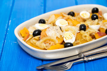 sweet potato with cod fish, onion and eggs on dish