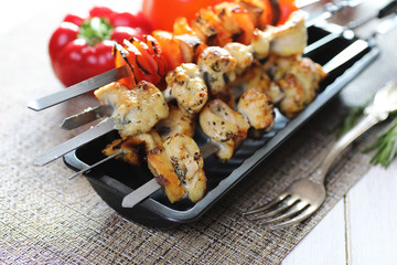 Kebab cooked on metal skewers with vegetables