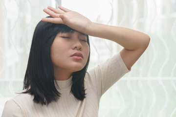 Fototapeta premium Woman with headache or cold in her room - health concept.