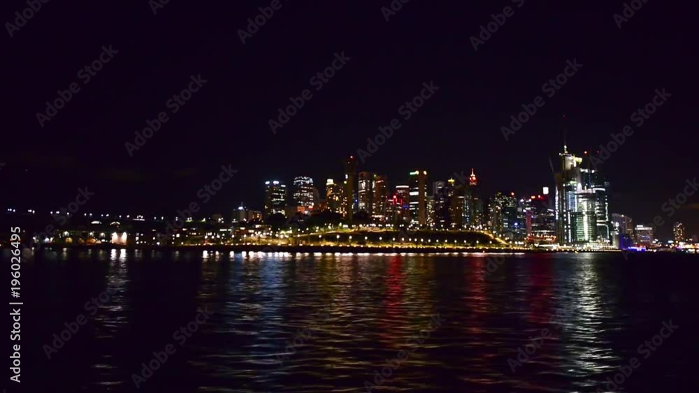 Wall mural Sydney night skyline from the sea, view from moving boat