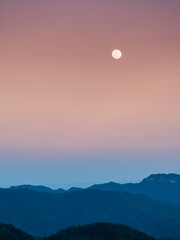 summer travel concept from sunlight and sunset with layer of mountain and twilight sky background