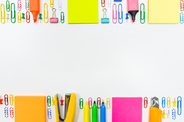 flat lay of office or school stationary including stapler, paper note, paperclip, pen, cutter and highlighter with copy space