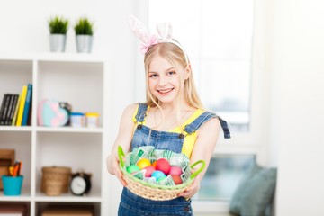 Teenage girl holding Easter eggs