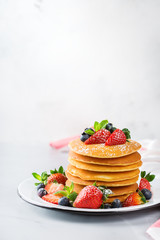 Stack of homemade pancakes for breakfast with berries