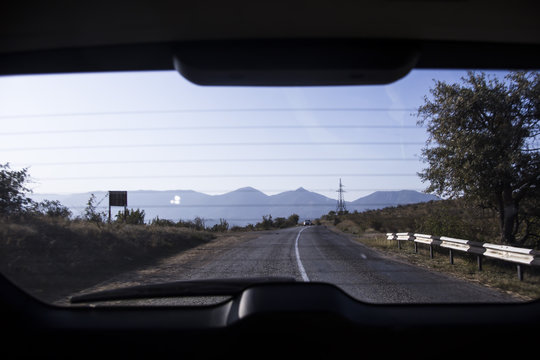 Fototapeta A view of the years through the rear window of the car. Crimean mountains. Travels