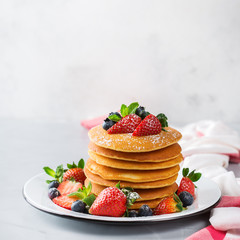Stack of homemade pancakes for breakfast with berries