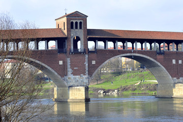 Italy - Pavia - The Covered Bridge (also called Ponte Vecchio) on the ticino with the Cathedral of...