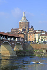 Italy - Pavia - The Covered Bridge (also called Ponte Vecchio) on the ticino with the Cathedral of the city in the background