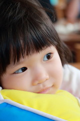 Obraz premium Asian girl close up portrait look to something 