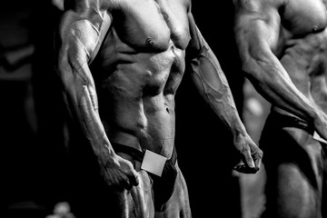 Fototapeta man athletes bodybuilders in relaxed poses  bodybuilding competition obraz
