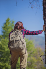 Young girl hiking standing relax and View map beside the tree.