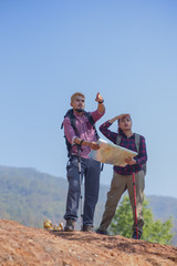 Young attractive couple hiking in the forest.
