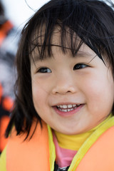 Asian girl with smiling face and life jacket