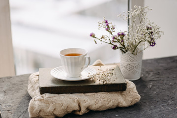 Cup of tea, knit a blanket, flowers in the window