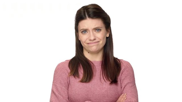 Portrait of outraged woman with brown hair shaking head and expressing disagreement, isolated on white background. Concept of emotions