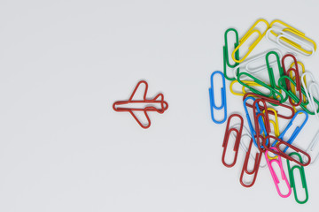 Business concept for group of stacked paperclip with another one red plane paperclip is point to...