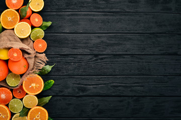 A set of citrus fruit. Orange, tangerine, grapefruit, lemon. On a wooden background. Top view. Copy space.