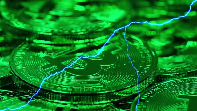 Blockchain technology, Bitcoins mining concept in green light with lightning, macro shot of bitcoins. Cryptocurrency Bitcoin, BTC, coins rotates in green light, power consumption concept