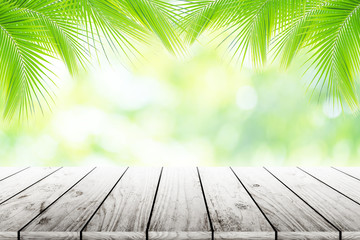 Empty wooden table with party in coconut leafs in resort garden background blurred.
