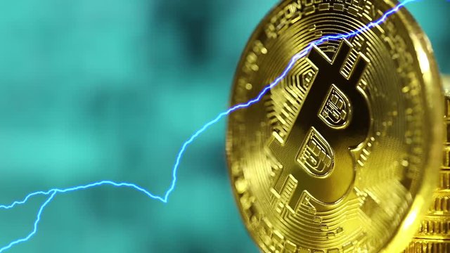 Blockchain technology, bitcoins mining concept with lightnings, macro shot of bitcoin. Cryptocurrency Bitcoin, BTC, power consumption concept