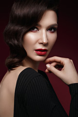 beautiful girl in Hollywood image with wave hair and classic makeup. Beauty face. Photo taken in the studio.