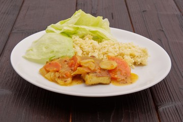Tofu and vegetables with millet on a table