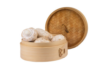White mushrooms in a bamboo container. Isolate on white backgrou
