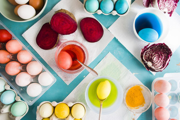 Dyeing eggs for Easter holidays, coloring with different red  color and tonality using food...