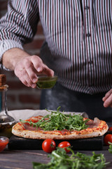The man passes the pesto sauce