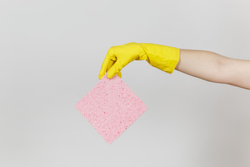 Close up of female hand in yellow gloves horizontal holds pink absorbent napkin for cleaning and...