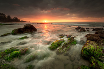 view of seascape during sunset with waves trails.