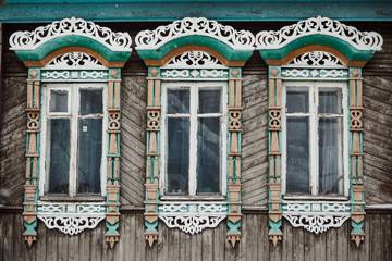 Fototapeta na wymiar Three windows with decorative wood carving frame