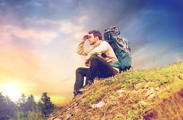 traveler with backpack hiking over sky background