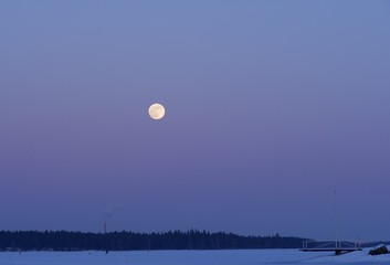 A shining and golden full moon over the pastel colour sky, Espoo, Finland
