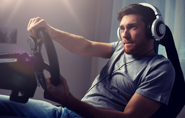 man playing car racing video game at home