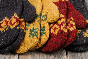 Brown, yellow and red handmade mittens. Front view.	