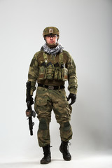 Full-length picture of soldier with gun in his hand