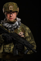 Fototapeta premium Photo of soldier in safety glasses with gun