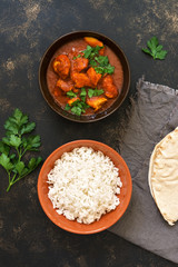 Chicken Tikka masala with rice in the bowl. Indian food. Top view, copy space.