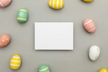 Easter holiday background. Pastel coloured decorated easter eggs with a blank white label.